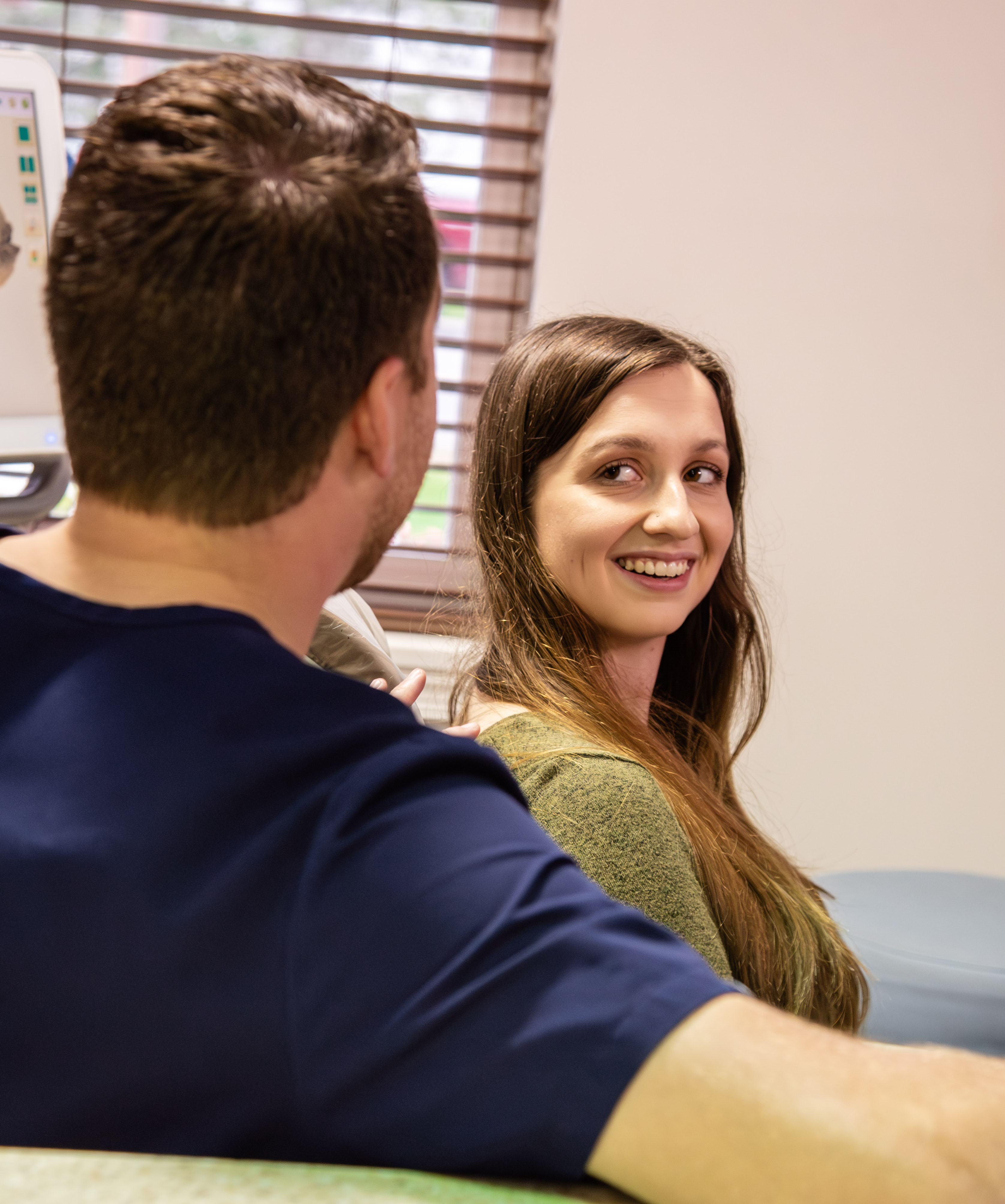 teen patient laughing with doctor